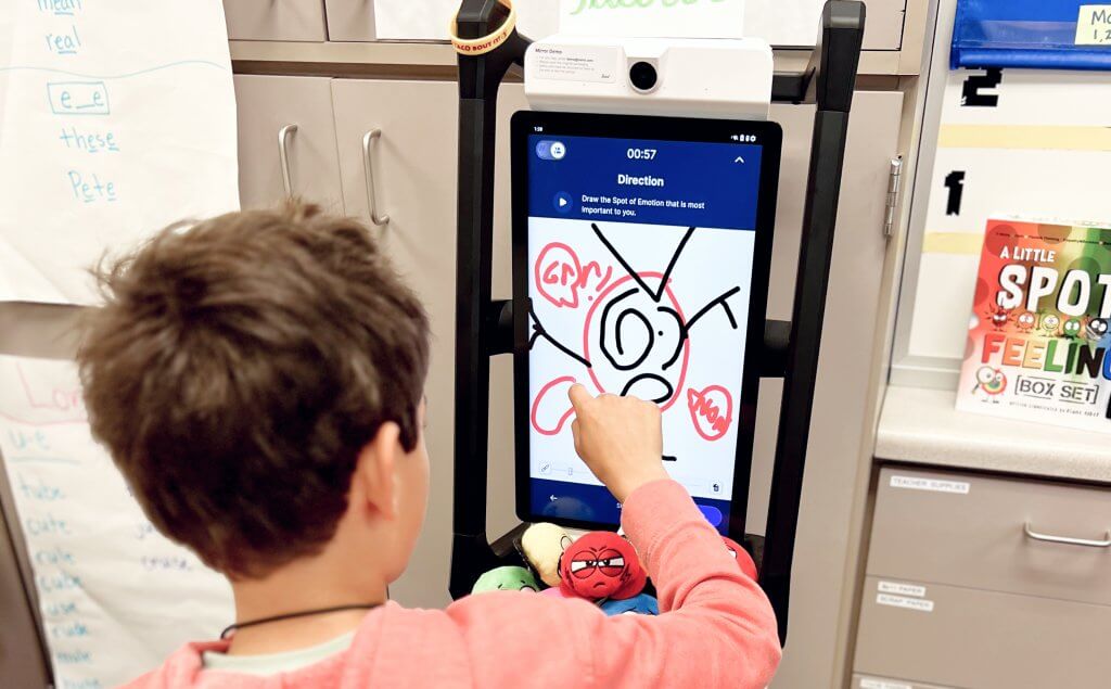 Student with autism drawing on interactive whiteboard with Mirror by Swivl