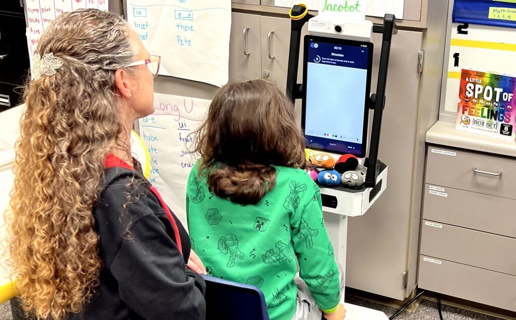 Teacher and student with autism review lesson directions on Mirror by Swivl