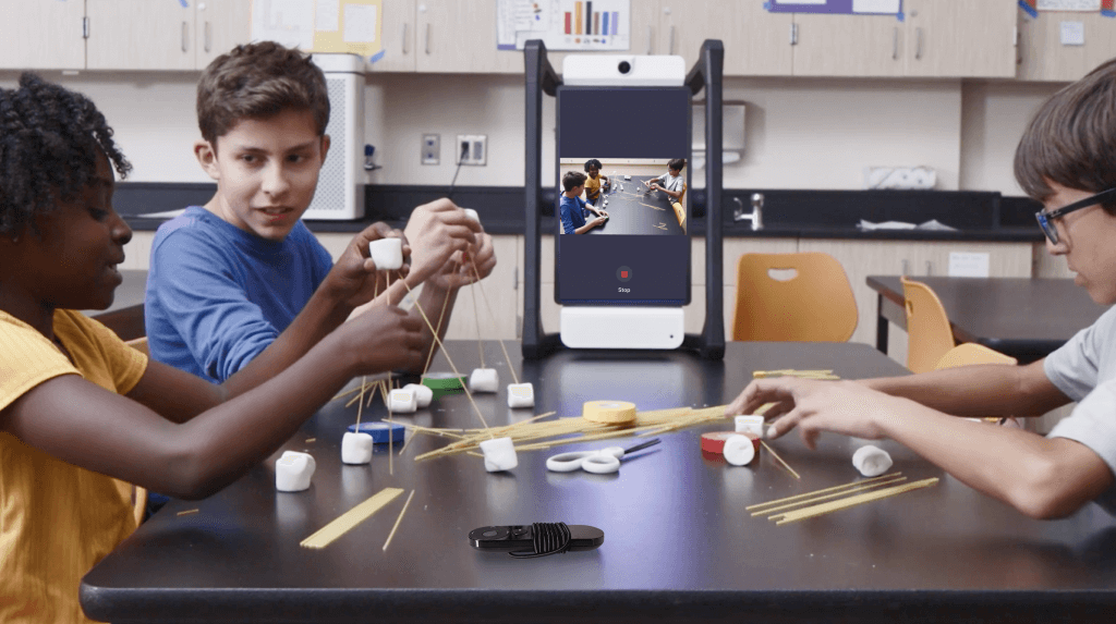 Students working in a small group guided by a Mirror device