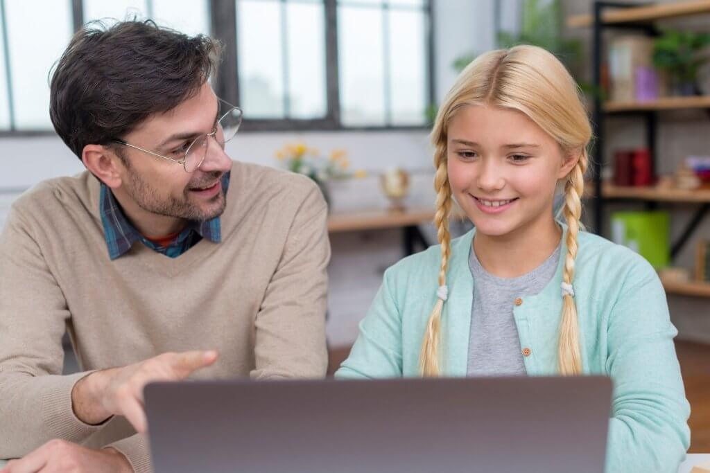 Teacher and student using AI technology in the classroom together